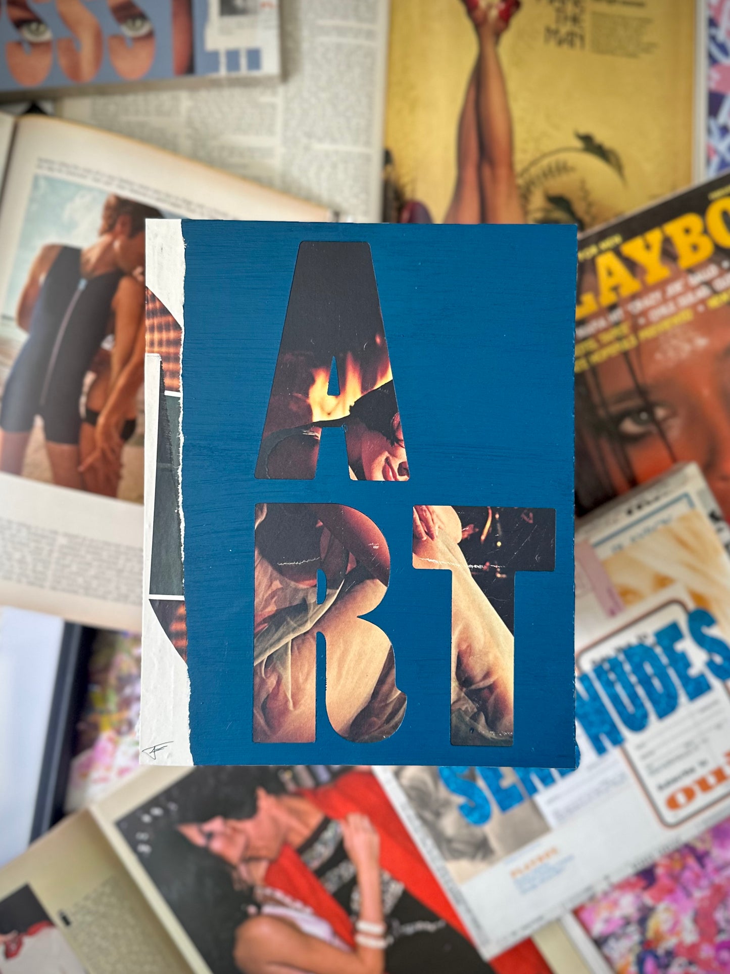 Mixed media collage artwork over vintage magazines 